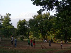 Soccer in Africa. No grass, no nets, tattered ball, some have shoes. Still fun!